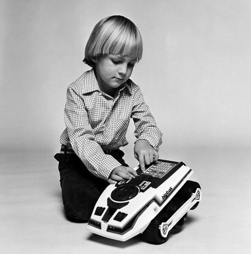 Young boy playing with BigTrak toy