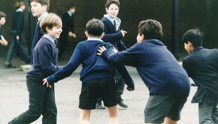 Kids playing British Bulldog in a UK School during the 1980s