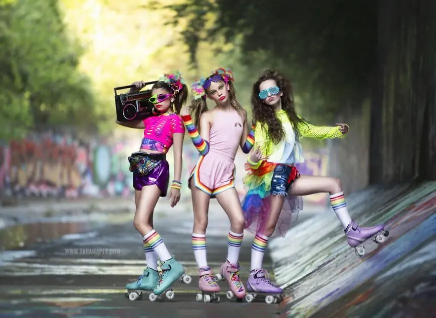 3 girls dressed in 80s clothes wearing rollerskates