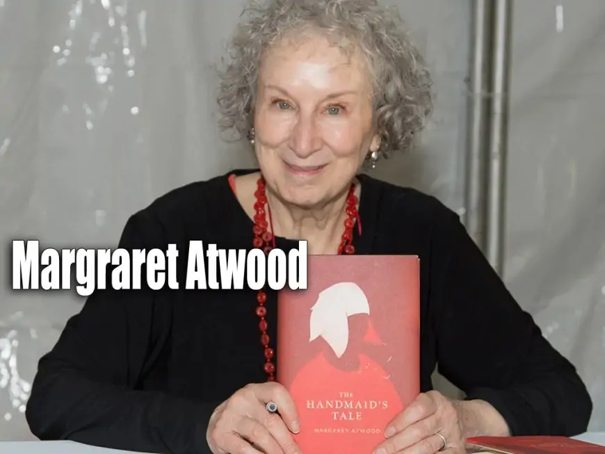 Margaret Atwood holding her book: The Handmaid's Tale